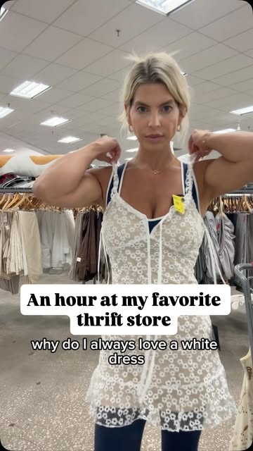 Melissa filming a vertical try on video wearing a white dress.
